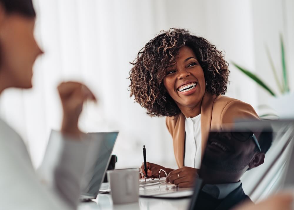 Businesswoman smiling sitting a table